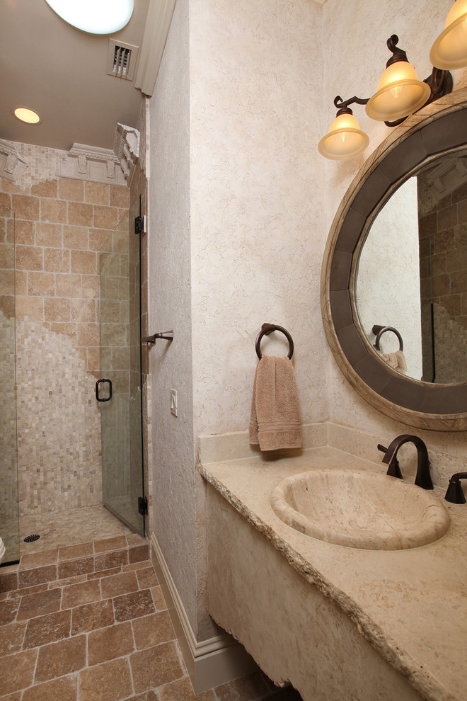 Photo of a traditional bathroom in Miami with a drop-in sink, stone tile and travertine floors.