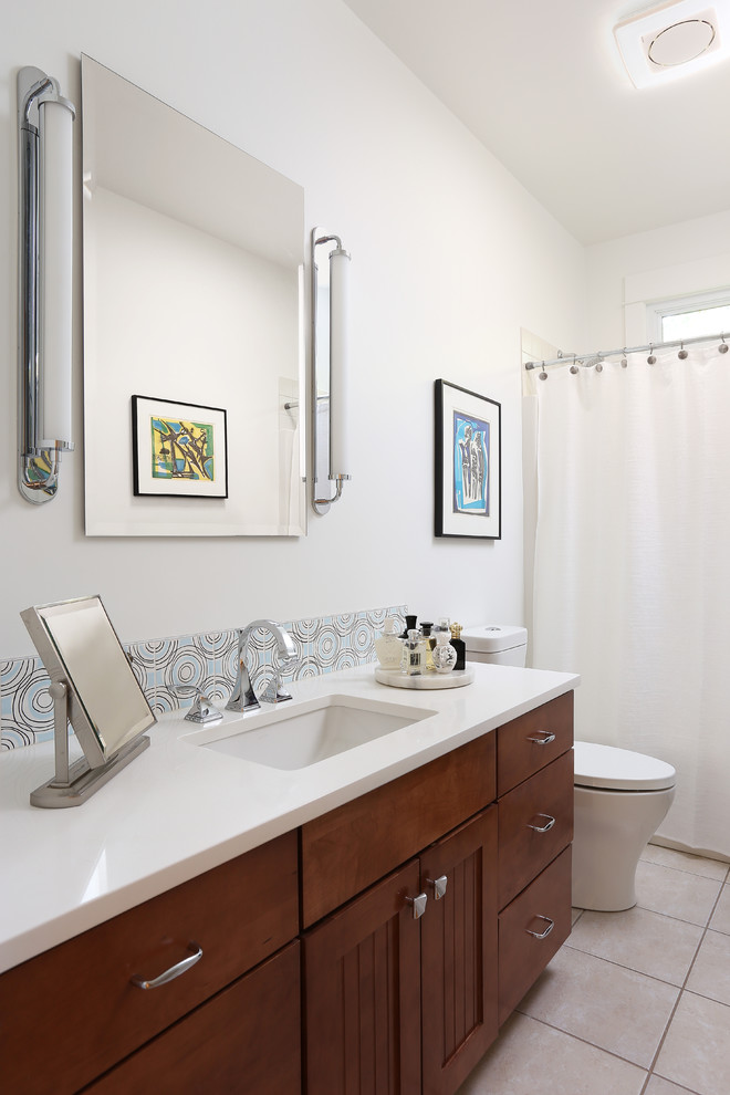 Design ideas for a small contemporary bathroom in Grand Rapids with orange cabinets, an alcove tub, a shower/bathtub combo, a two-piece toilet, multi-coloured tile, ceramic tile, white walls, porcelain floors, an undermount sink, engineered quartz benchtops, beige floor and white benchtops.