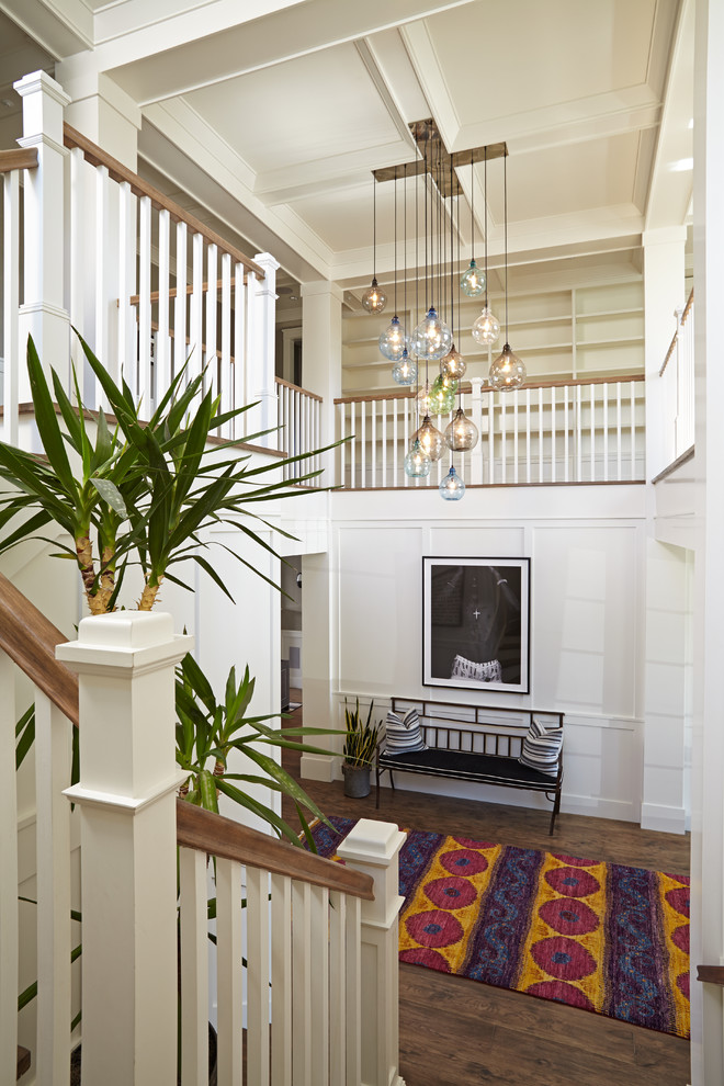 Inspiration for a transitional foyer in Orange County with white walls and dark hardwood floors.