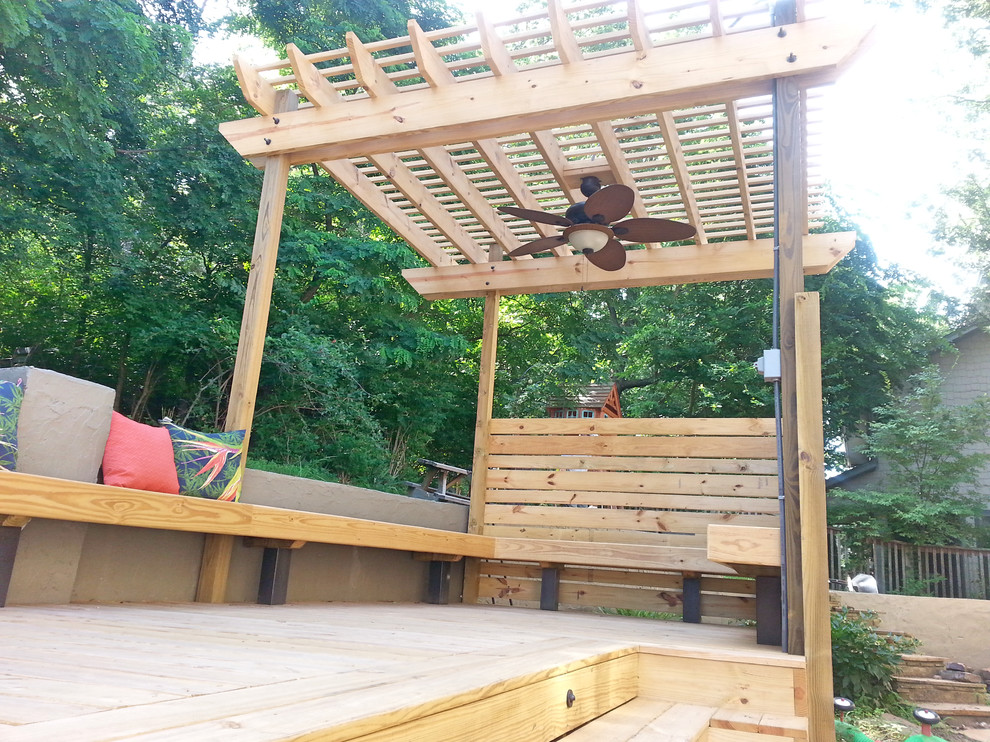 Inspiration for a large backyard deck remodel with a pergola