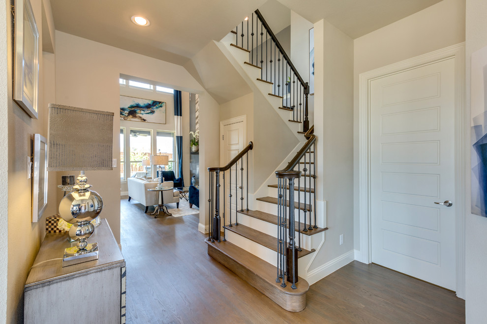 This is an example of a contemporary wood u-shaped staircase in Dallas with painted wood risers.