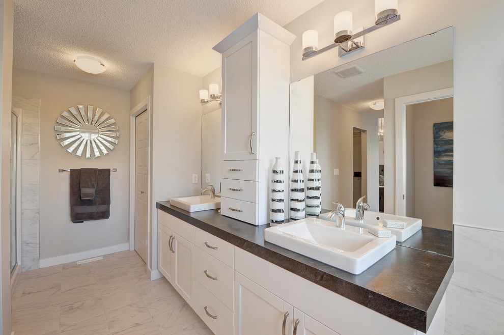 Example of a mid-sized transitional kids' ceramic tile and white floor alcove bathtub design in Edmonton with shaker cabinets, white cabinets, a two-piece toilet, gray walls, a vessel sink and laminate countertops