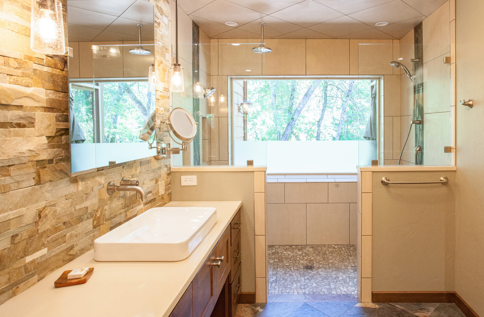 Photo of a large contemporary master bathroom in Other with recessed-panel cabinets, medium wood cabinets, a double shower, green tile, stone tile, beige walls, porcelain floors, a vessel sink, engineered quartz benchtops, multi-coloured floor and an open shower.