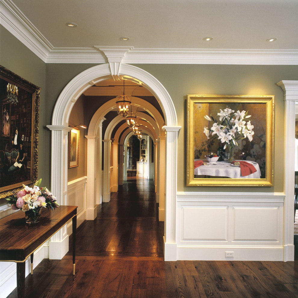 Design ideas for a large traditional entry hall in Boston with green walls and dark hardwood floors.