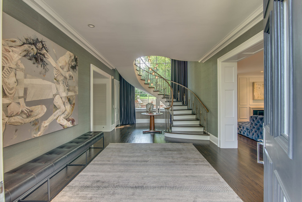 This is an example of a contemporary foyer in Nashville with grey walls, dark hardwood floors and brown floor.