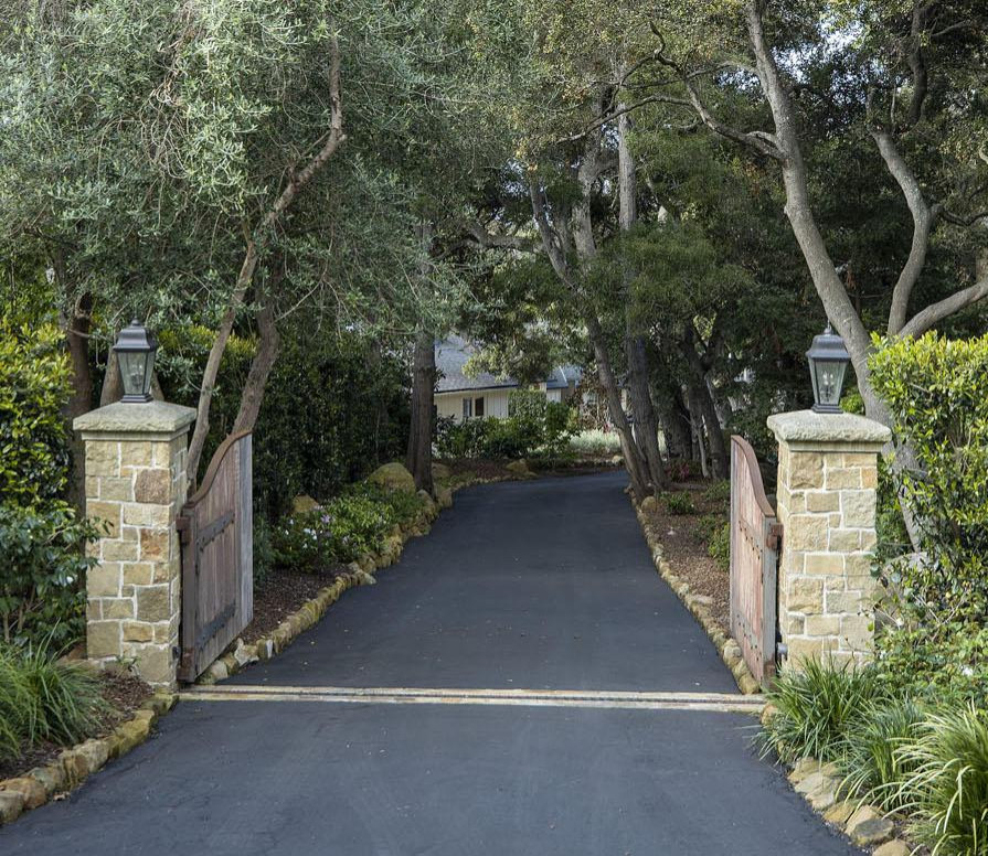 This is an example of a traditional backyard driveway in Santa Barbara with with a gate.