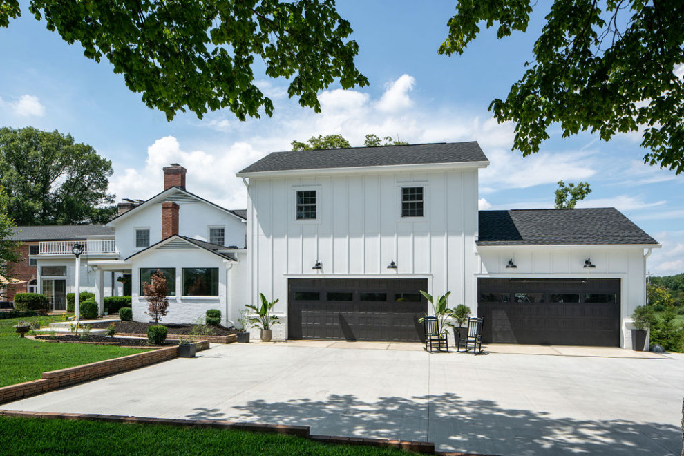 Inspiration for a large transitional attached four-car garage in Columbus.