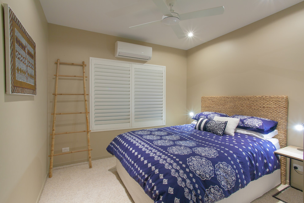 Inspiration for a beach style guest bedroom in Sunshine Coast with brown walls and carpet.