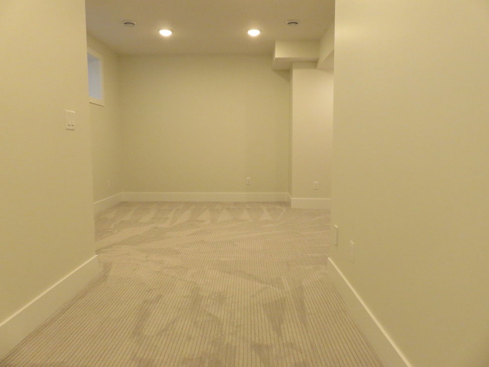 Example of a mid-sized transitional look-out carpeted and gray floor basement design in Calgary with white walls