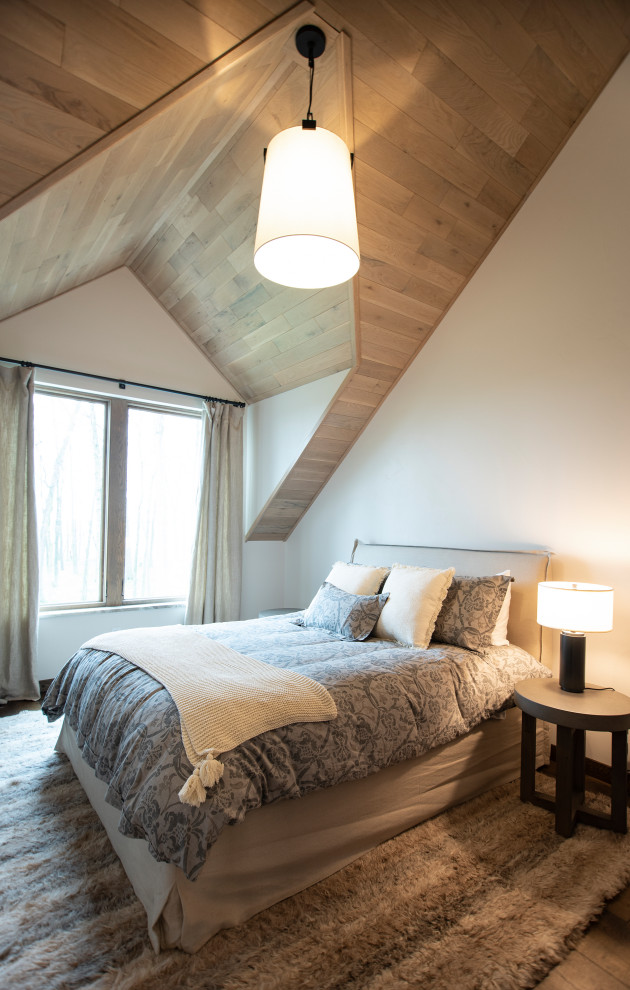 Bedroom - mid-sized rustic guest medium tone wood floor and vaulted ceiling bedroom idea with white walls