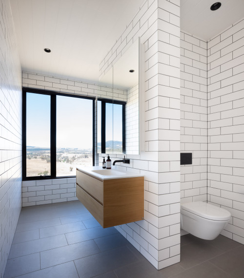 Timeless Charm: White Subway Tile Walls and Wood Floating Vanity in Contemporary Bathroom Ideas