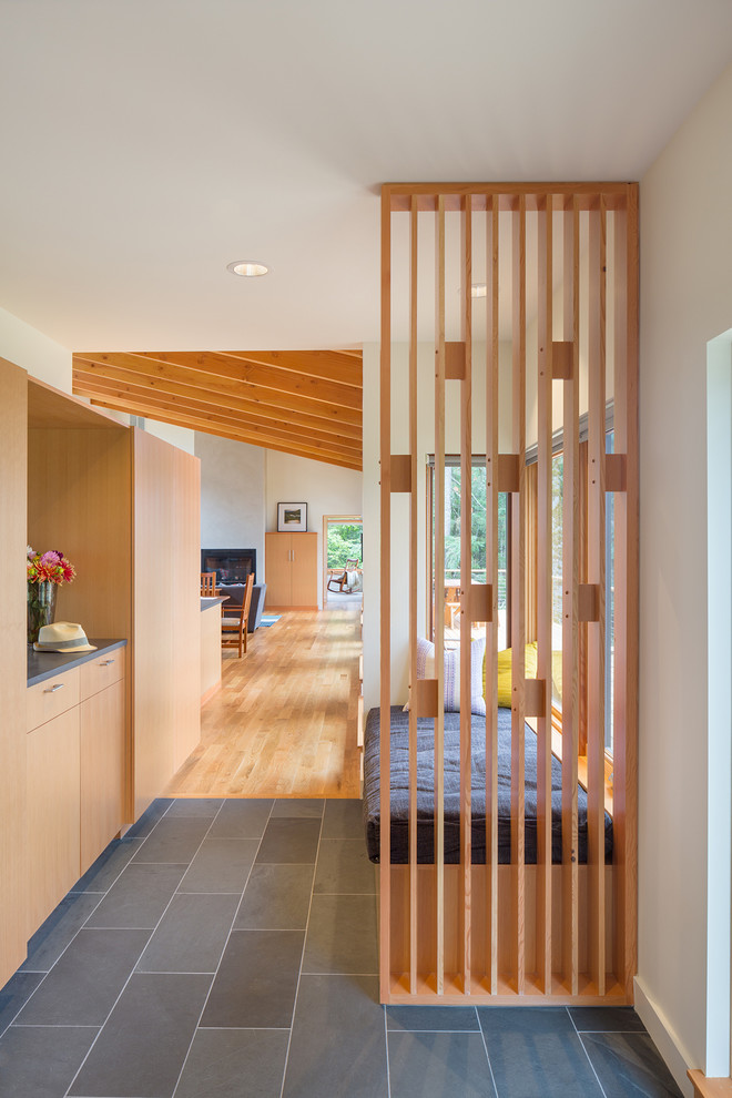 Mid-sized modern foyer in Portland with white walls, slate floors and a single front door.