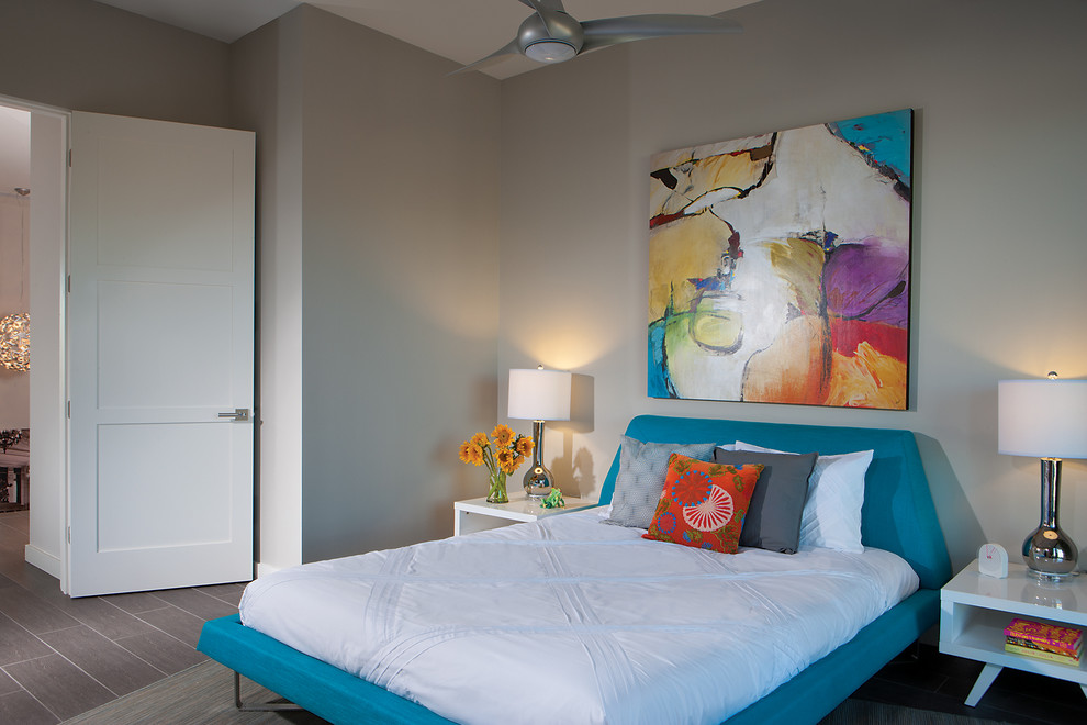 This is an example of a small modern guest bedroom in Phoenix with white walls and porcelain floors.
