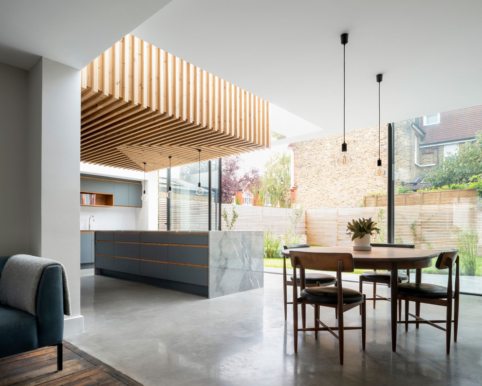 Inspiration for a large contemporary l-shaped eat-in kitchen in London with an undermount sink, flat-panel cabinets, grey cabinets, marble benchtops, white splashback, concrete floors, with island, grey floor and grey benchtop.