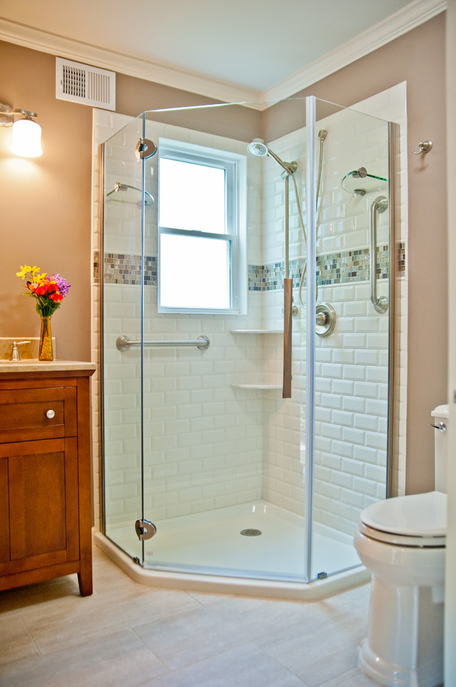 Mid-sized traditional 3/4 bathroom in New York with shaker cabinets, dark wood cabinets, a corner shower, a one-piece toilet, white tile, subway tile, brown walls and porcelain floors.