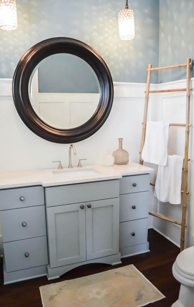 Design ideas for a mid-sized transitional powder room in Charleston with shaker cabinets, grey cabinets, blue walls, dark hardwood floors, an undermount sink, engineered quartz benchtops and brown floor.