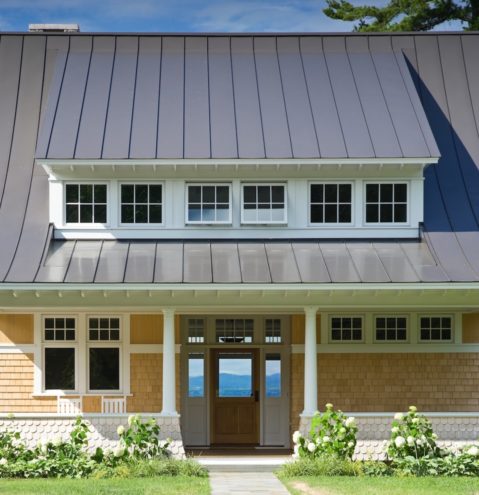 Photo of a beach style exterior in Burlington with wood siding.