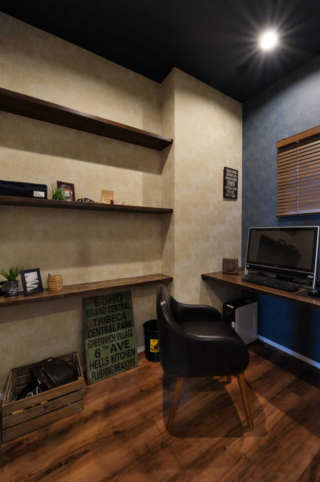 This is an example of an industrial study room in Other with no fireplace, a built-in desk and brown floor.