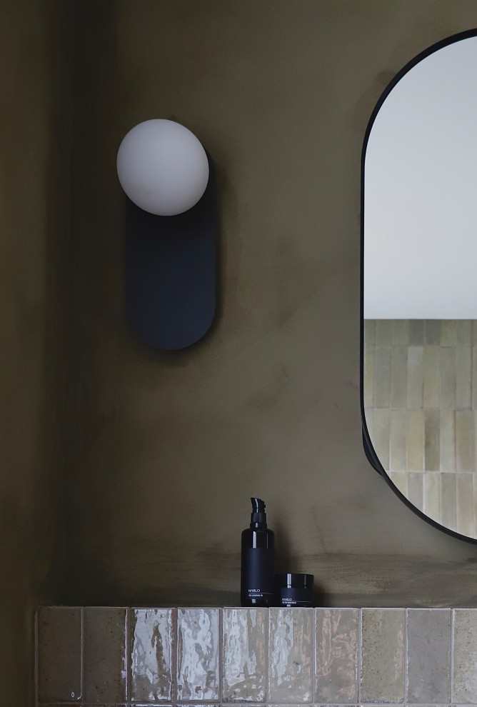 Photo of a bathroom in Canberra - Queanbeyan with medium wood cabinets, green tile, green walls, wood benchtops, a double vanity and a floating vanity.