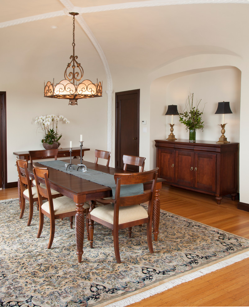 Photo of a large mediterranean dining room in San Francisco with beige walls, medium hardwood floors and no fireplace.