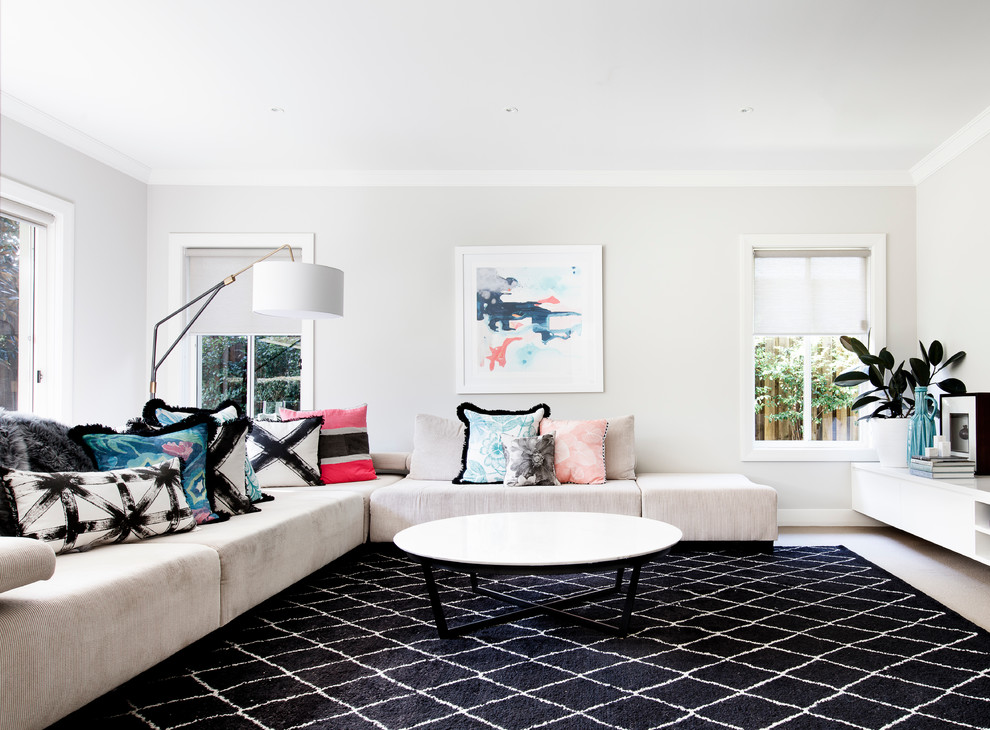 This is an example of a large contemporary enclosed family room in Sydney with carpet and a freestanding tv.