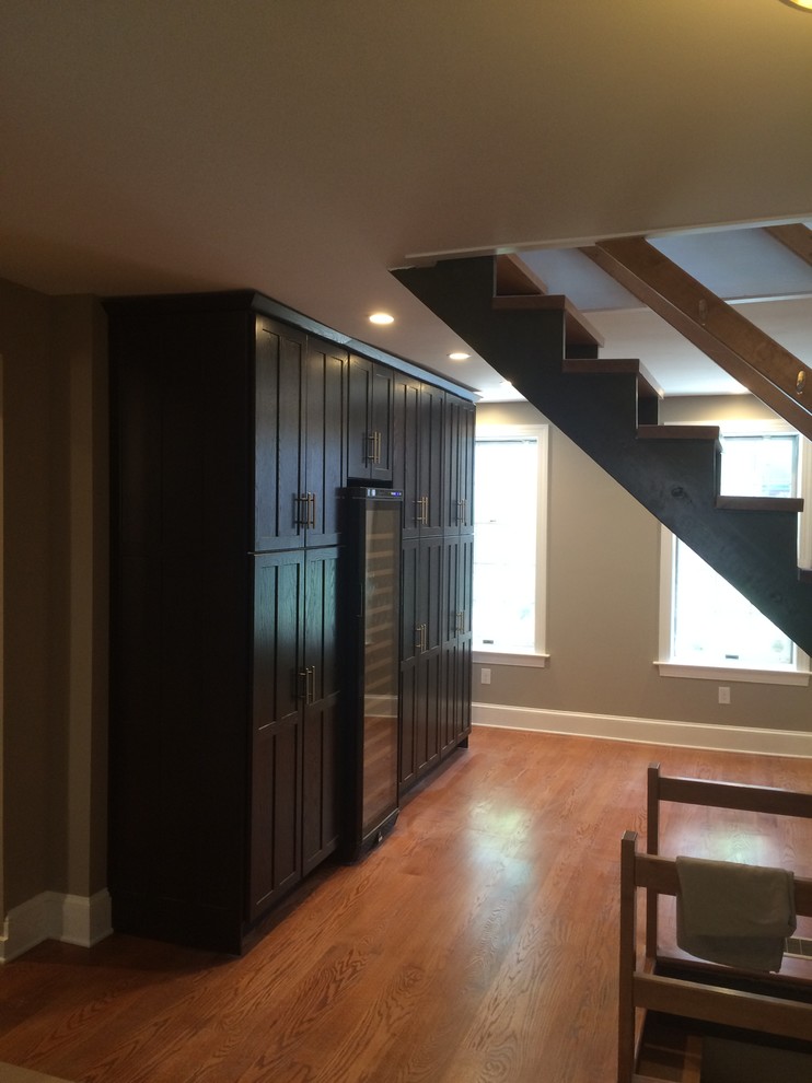 Design ideas for a mid-sized arts and crafts wine cellar in Philadelphia with medium hardwood floors and brown floor.
