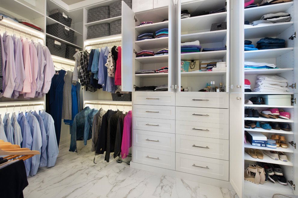 This is an example of a mid-sized modern gender-neutral walk-in wardrobe in Chicago with shaker cabinets, white cabinets, marble floors and multi-coloured floor.