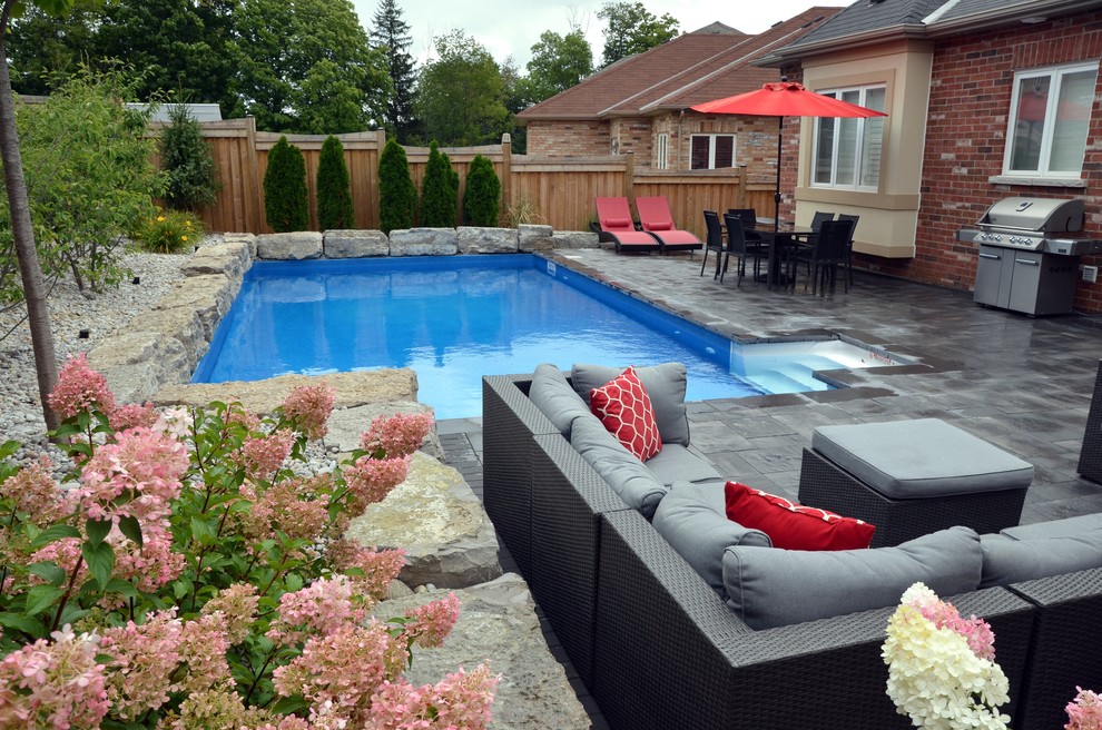 Pool - mid-sized transitional backyard concrete paver and rectangular lap pool idea in Toronto