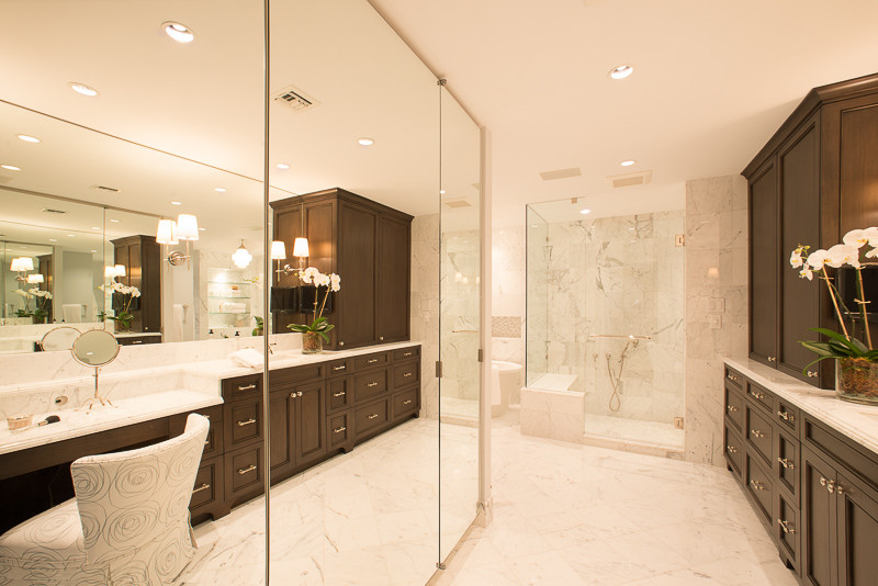Inspiration for a large transitional master bathroom in Houston with beaded inset cabinets, dark wood cabinets, a freestanding tub, a corner shower, gray tile, white tile, marble, white walls, marble floors, an undermount sink, marble benchtops, white floor and a hinged shower door.
