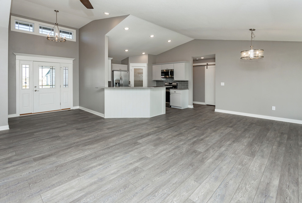 Inspiration for a large transitional medium tone wood floor and gray floor front door remodel with gray walls and a white front door