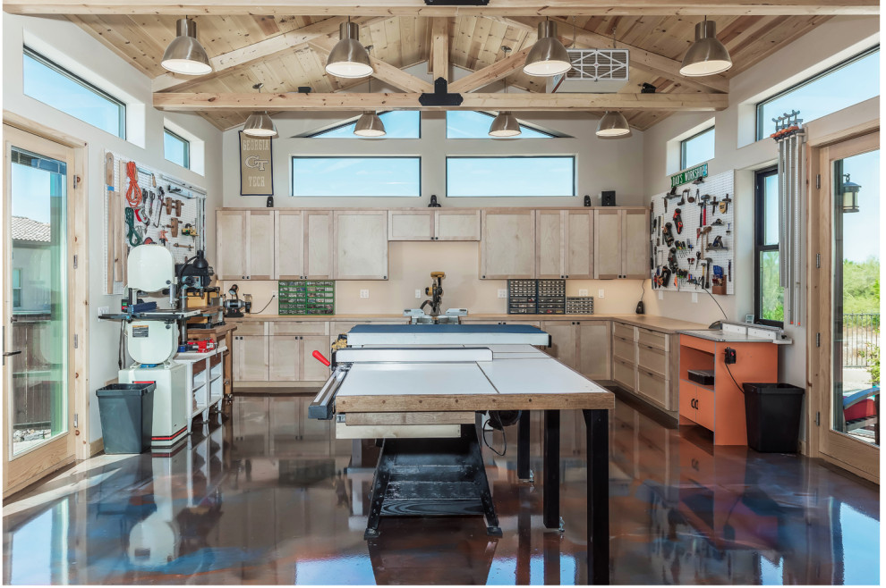 This is an example of a large arts and crafts craft room in Phoenix with beige walls, concrete floors and multi-coloured floor.