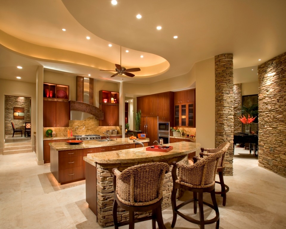Inspiration for a large contemporary u-shaped open plan kitchen in Phoenix with a single-bowl sink, flat-panel cabinets, medium wood cabinets, granite benchtops, beige splashback, stainless steel appliances, travertine floors and multiple islands.