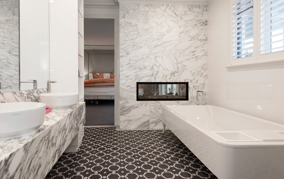 Photo of a large contemporary master bathroom in Melbourne with flat-panel cabinets, grey cabinets, a freestanding tub, white walls, mosaic tile floors, a vessel sink, multi-coloured floor, multi-coloured benchtops, a double vanity, a double shower, multi-coloured tile, marble, marble benchtops, an open shower, an enclosed toilet and a floating vanity.