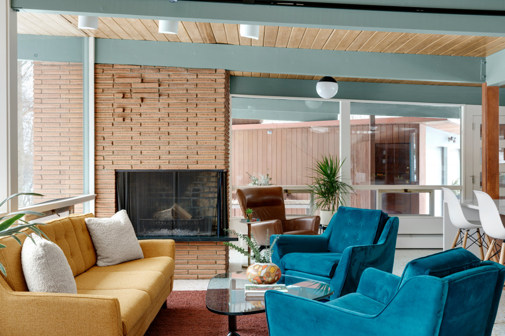 Mid-sized midcentury open concept living room in Minneapolis with white walls, a corner fireplace, a brick fireplace surround, white floor, exposed beam and wood walls.