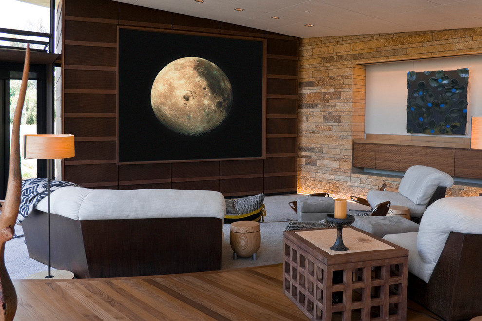 Inspiration for a contemporary open concept home theatre in Los Angeles with a projector screen.
