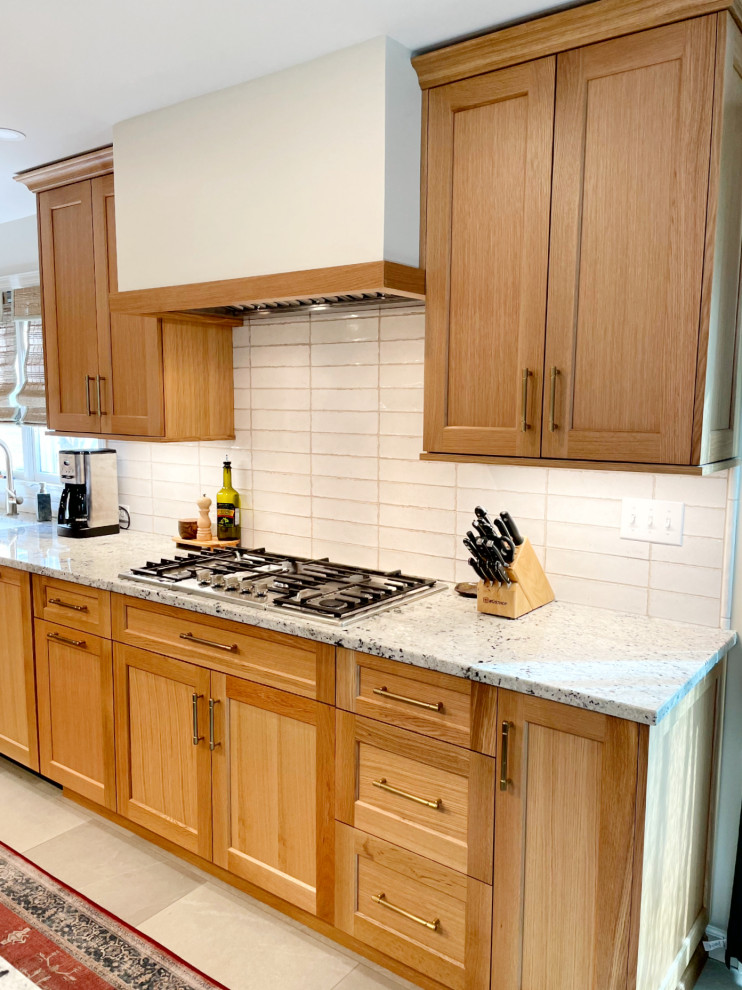 Transitional kitchen in Other with recessed-panel cabinets, green cabinets, granite benchtops, white splashback, ceramic splashback, stainless steel appliances, ceramic floors, with island and grey floor.