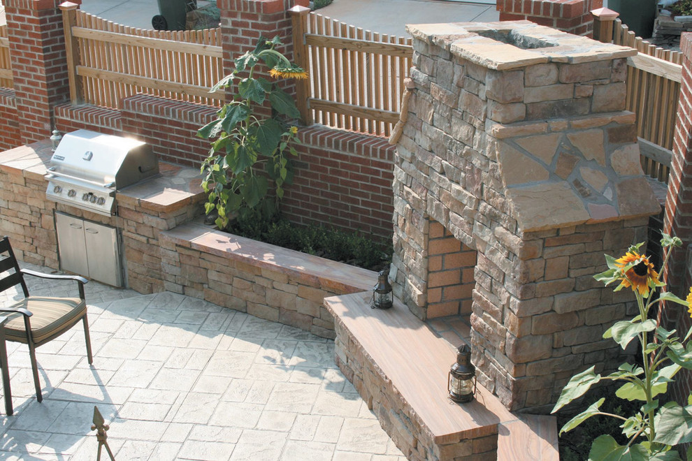 Inspiration for a mid-sized traditional backyard patio in Toronto with an outdoor kitchen, natural stone pavers and no cover.