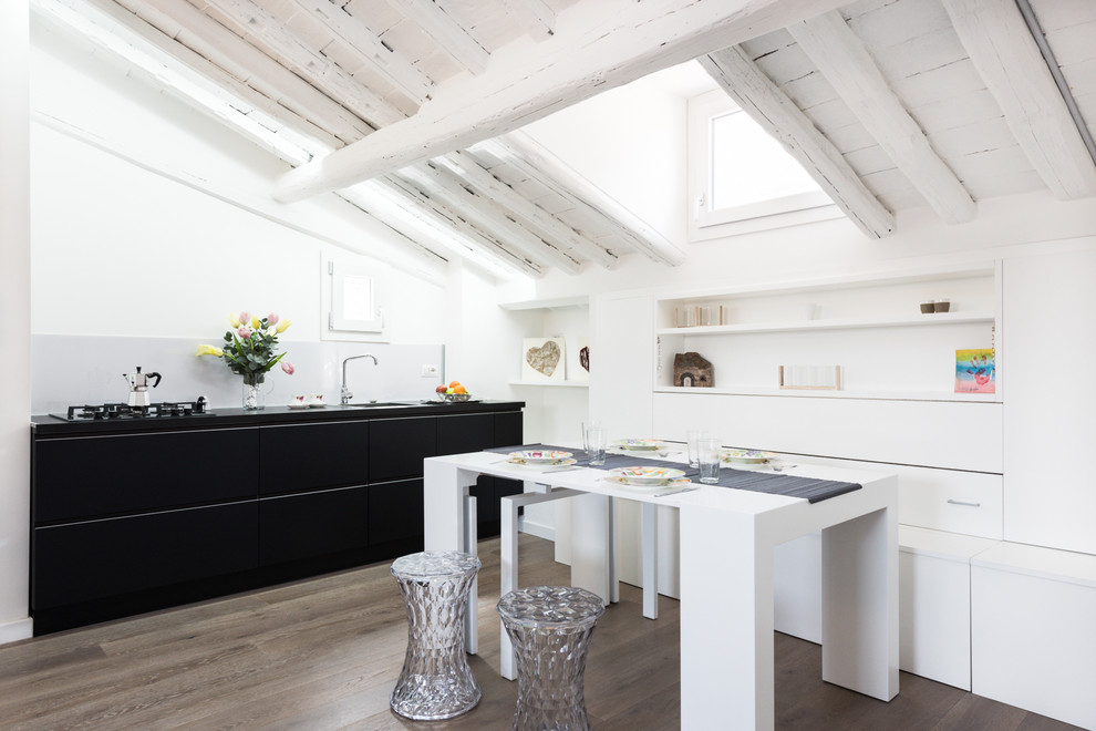 Photo of a small contemporary open plan dining in Rome with white walls and light hardwood floors.