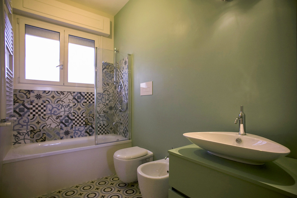 Exemple d'une salle de bain principale tendance de taille moyenne avec un placard à porte plane, des portes de placards vertess, une baignoire posée, WC suspendus, un carrelage vert, un mur vert, un sol en carrelage de céramique, une vasque, un plan de toilette en stratifié, un sol multicolore, des carreaux de céramique et un plan de toilette vert.