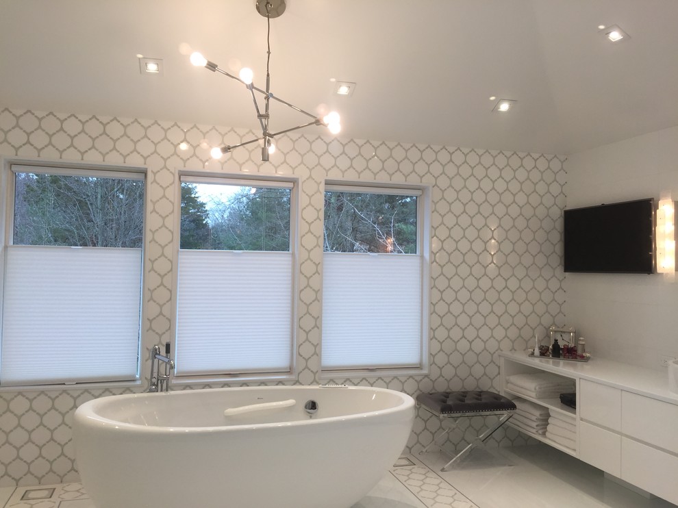 This is an example of a mid-sized contemporary master bathroom in New York with flat-panel cabinets, white cabinets, a freestanding tub, an alcove shower, a one-piece toilet, white tile, porcelain tile, a vessel sink, engineered quartz benchtops, a hinged shower door, white walls, porcelain floors and white floor.