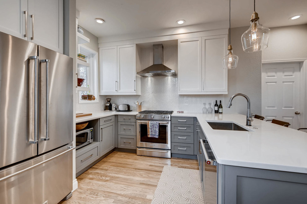 Eat-in kitchen - small transitional u-shaped light wood floor and brown floor eat-in kitchen idea in Denver with an undermount sink, shaker cabinets, white cabinets, granite countertops, white backsplash, ceramic backsplash, stainless steel appliances, a peninsula and white countertops