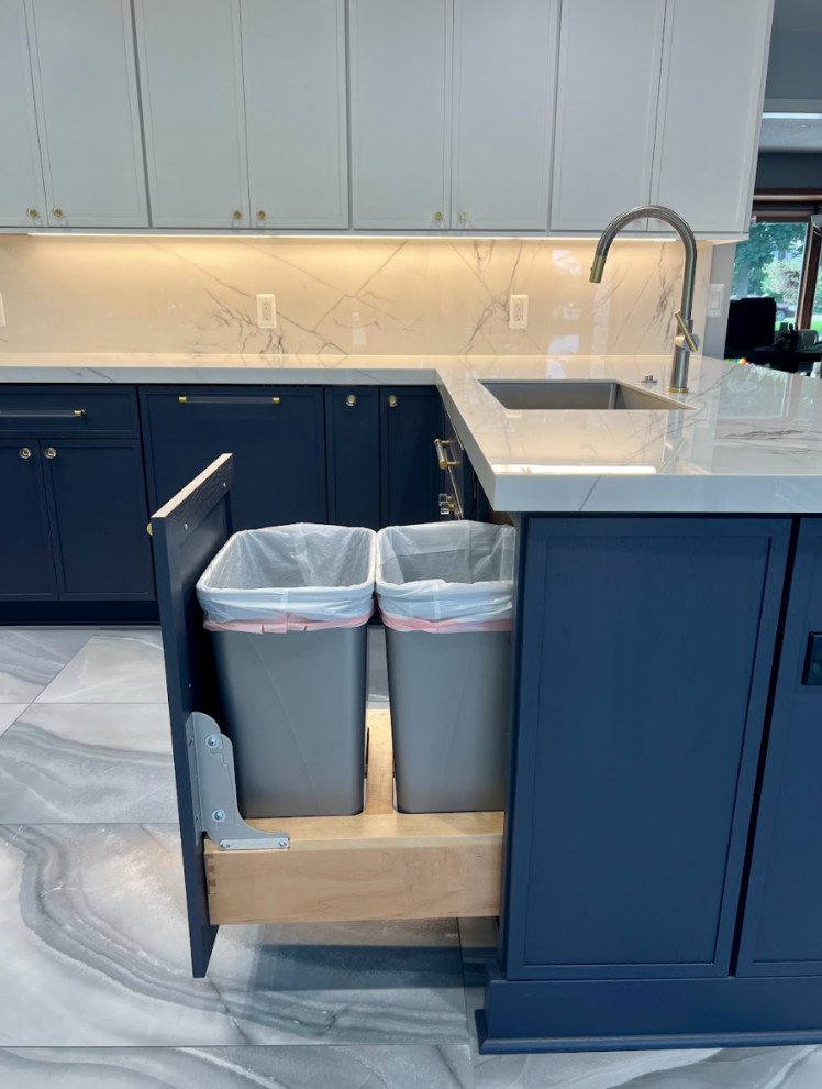 This is an example of a contemporary single-wall separate kitchen in Detroit with flat-panel cabinets, blue cabinets, granite benchtops, white splashback, granite splashback, porcelain floors, blue floor and white benchtop.