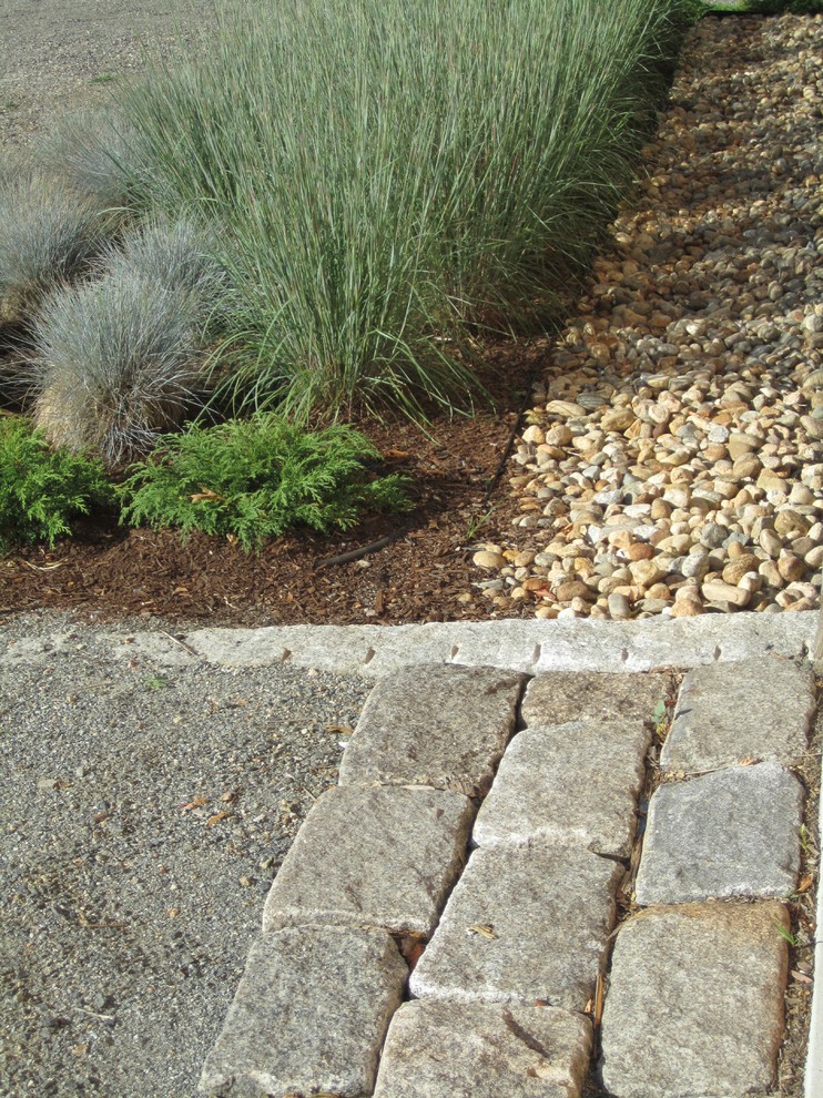 This is an example of a mid-sized transitional full sun and drought-tolerant front yard stone garden path in Boston for fall.