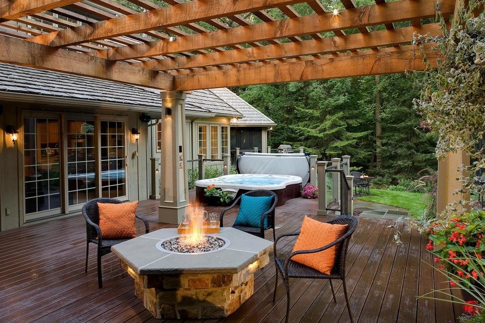 Photo of a mid-sized partial sun backyard landscaping in Minneapolis with a fireplace and decking for summer.