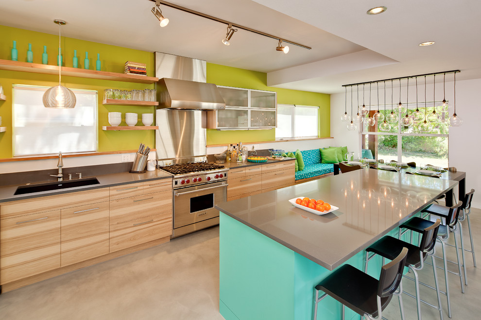 Inspiration for a large contemporary kitchen in Austin with an undermount sink, flat-panel cabinets, medium wood cabinets, quartz benchtops, green splashback, stainless steel appliances, concrete floors and with island.