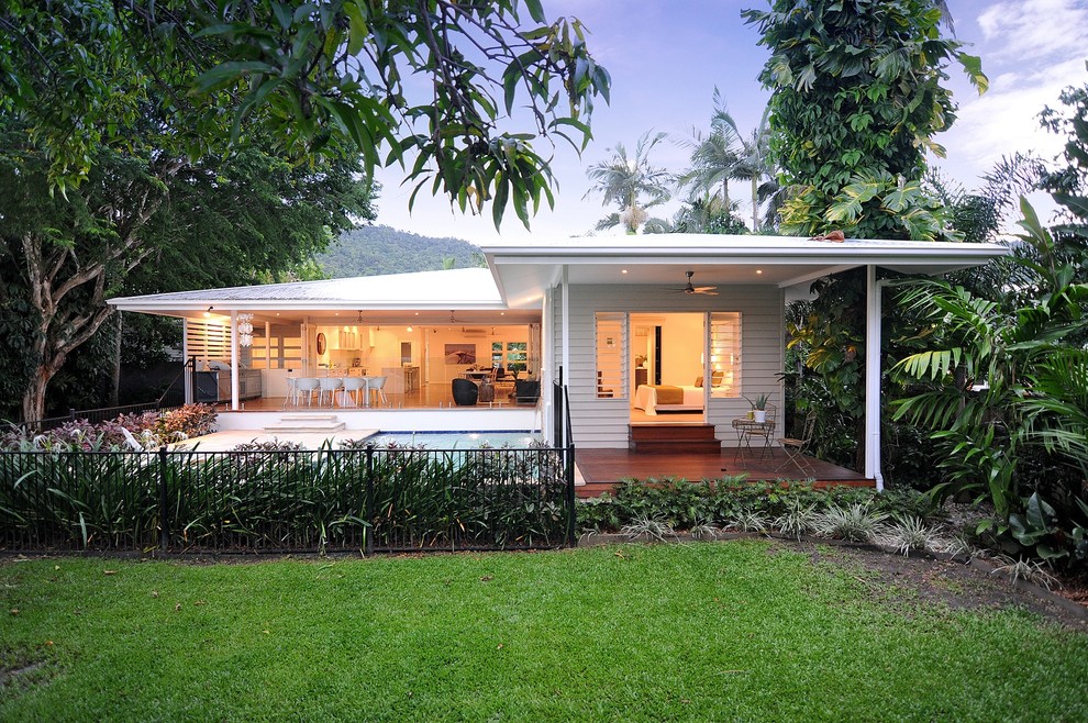 Design ideas for a large contemporary one-storey white exterior in Cairns with concrete fiberboard siding and a hip roof.
