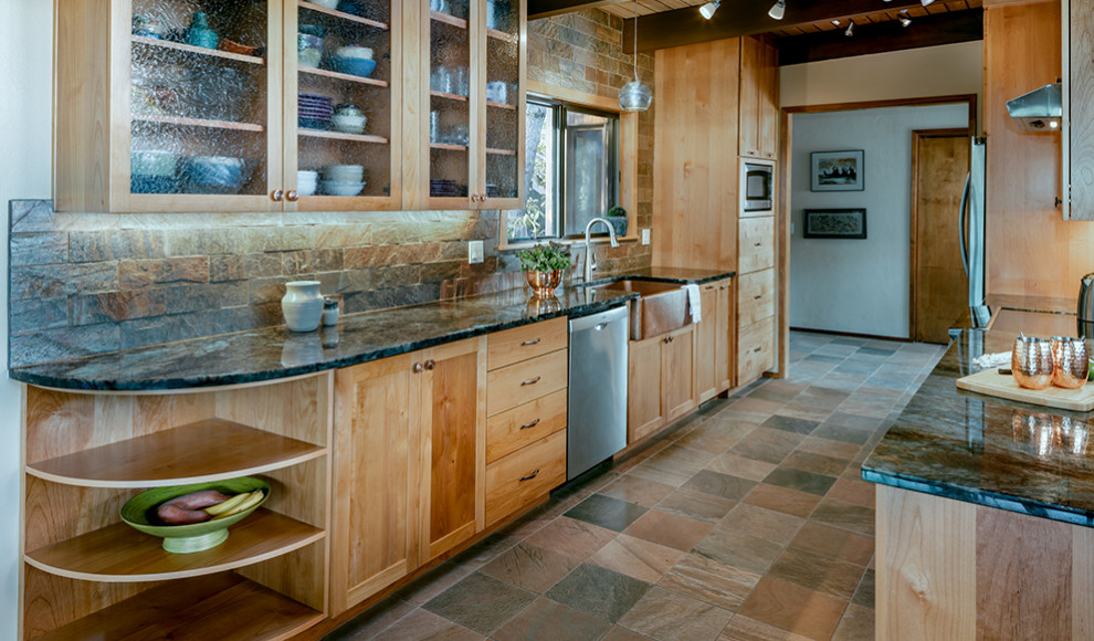 Photo of a small country galley eat-in kitchen in Other with a farmhouse sink, shaker cabinets, light wood cabinets, granite benchtops, slate splashback, stainless steel appliances, slate floors, no island, blue benchtop and wood.