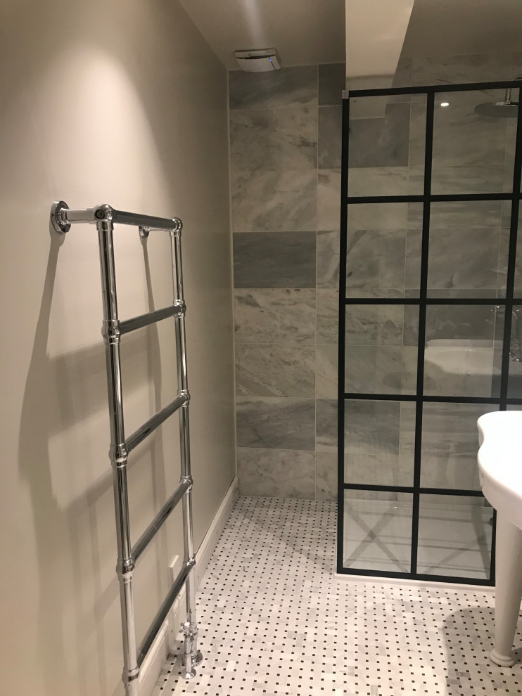 This is an example of a medium sized modern grey and black shower room bathroom in London with a walk-in shower, a one-piece toilet, white walls, mosaic tile flooring, white floors, an open shower, feature lighting and a single sink.
