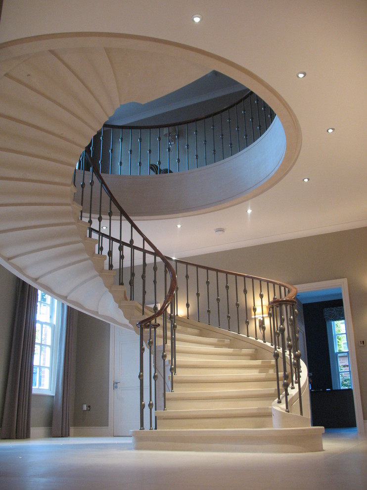 Large classic tiled curved staircase in London with tiled risers.