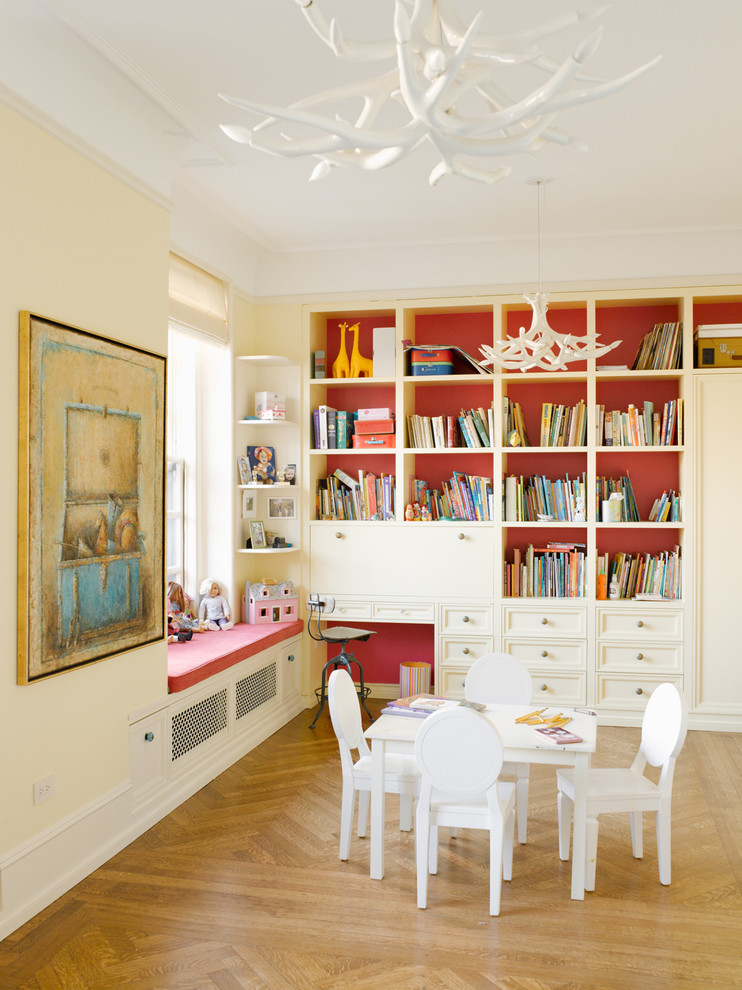 Photo of a mid-sized transitional gender-neutral kids' playroom for kids 4-10 years old in New York with light hardwood floors and multi-coloured walls.